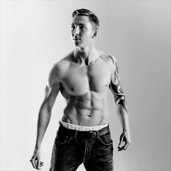 portrait in black and white of male model with muscle torso by portrait photographer in Glasgow, Scotland