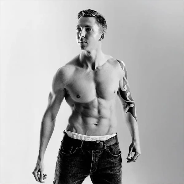portrait in black and white of male model with muscle torso by portrait photographer in Glasgow, Scotland