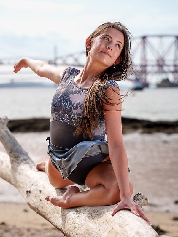 Dancer_balances_elegantly_driftwood