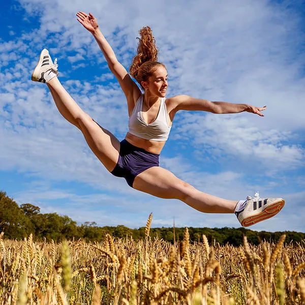 dancer-leaps-wheatfield-bluesky